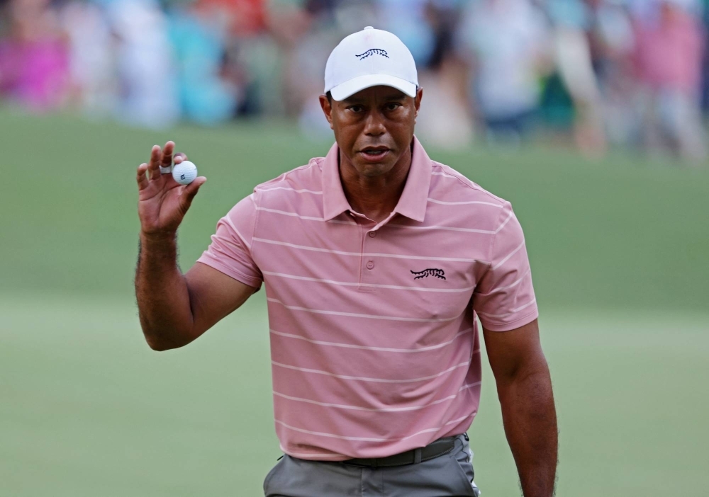 Tiger Woods acknowledges the crowd on the sixth hole during the first round of the Masters in Augusta, Georgia, on Thursday.
