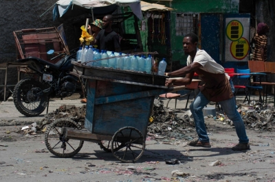 A street vendor flees from gang violence in Port-au-Prince, Haiti, on Monday.