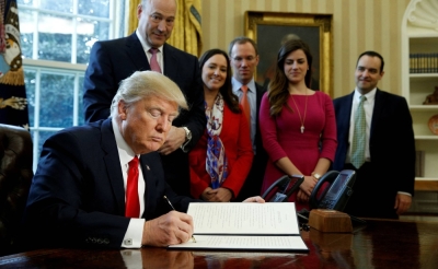 Then-U.S. President Donald Trump signs an executive order rolling back regulations from the 2010 Dodd-Frank law on Wall Street reform at the White House in Washington in February 2017.