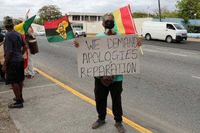 A protester demands the United Kingdom make reparations for slavery, outside the British High Commission, in Kingston, Jamaica, in March 2022. 