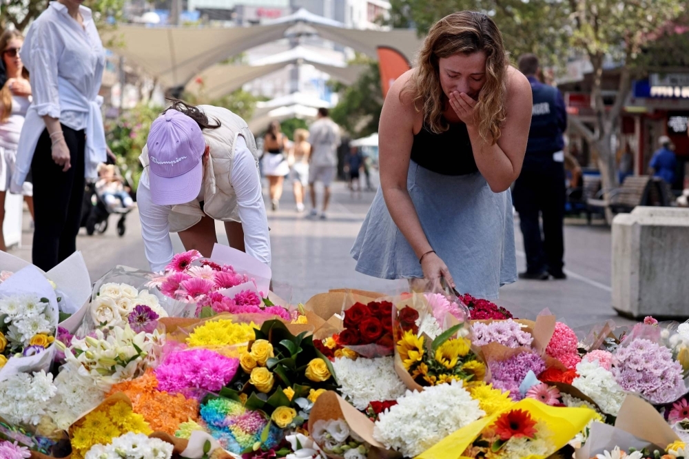 Flowers outside the Westfield Bondi Junction shopping mall in Sydney on Sunday, the day after a 40-year-old man with mental illness roamed the packed shopping center killing six people and seriously wounding a dozen others