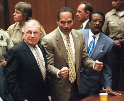 O.J. Simpson listens to the not guilty verdict after his murder trial with his attorneys F. Lee Bailey (left) and Johnnie Cochran Jr. (right) in Los Angeles in October 1995.  