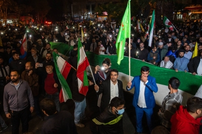 Iranians gather at Palestine Square to celebrate Iran’s attack on Israel, holding up their phones with the flash on, in Tehran on Sunday.