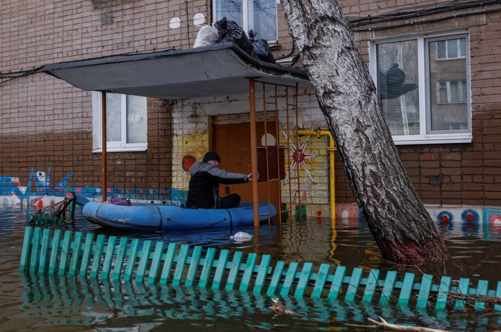 A man sits in an inflatable boat in a flooded residential area in Orsk, in the Orenburg region of Russia, on Saturday.