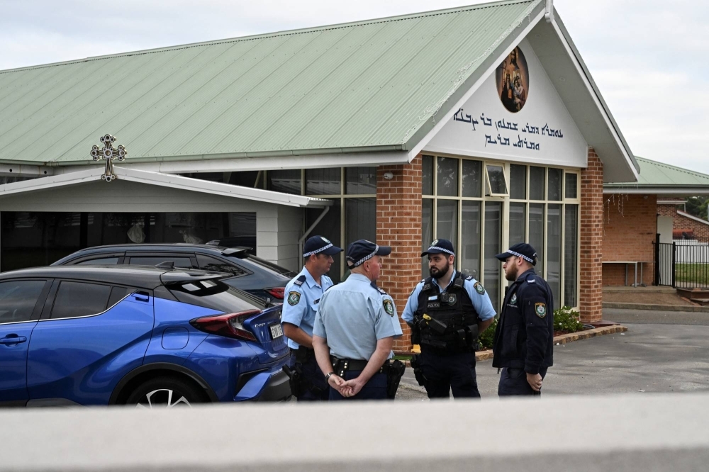 Police stand outside the Assyrian Christ The Good Shepherd Church after a knife attack that took place during a service the night before, in Wakely in Sydney on Tuesday.