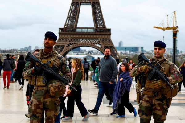 Armed French soldiers patrol Trocadero square near the Eiffel Tower Stadium, Champ de Mars Arena and Grand Palais Ephemere venues under construction for the Paris 2024 Olympic and Paralympic Games, in Paris on April 1.