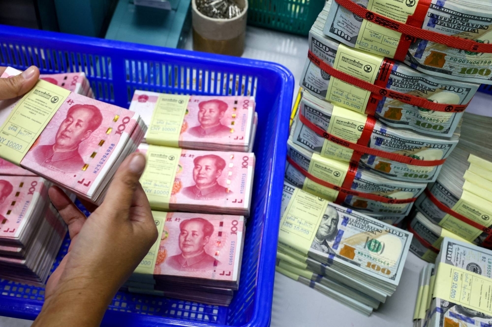 China's yuan is at five-month lows and has lost 1.9% to the dollar this year as foreign investors pull more money out of its struggling markets. 