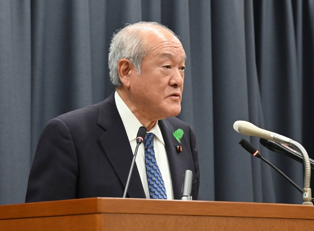 Finance Minister Shunichi Suzuki speaks to reporters in Tokyo on Tuesday.