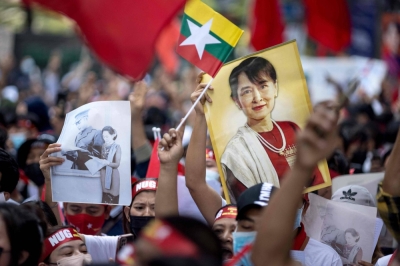 Protesters hold images of Aung San Suu Kyi and a flag of Myanmar during a demonstration outside the Embassy of Myanmar in Bangkok on Feb. 1, 2023, to mark the second anniversary of the coup in Myanmar. 