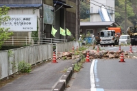 A national road is blocked by fallen rocks on Thursday following a magnitude 6.6 earthquake in Ozu, Ehime Prefecture, the previous day. | Jiji