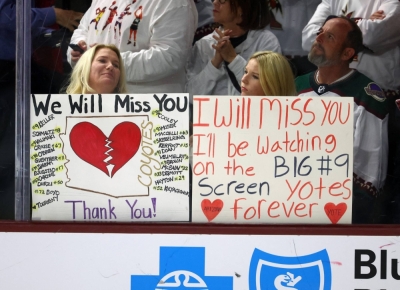 Arizona Coyotes fans hold up signs after the team's final game of the season on Wednesday in Tempe, Arizona. 