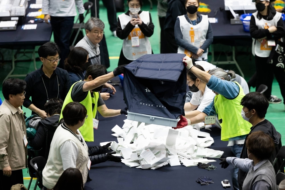 South Korean officials count ballots following a parliamentary election on April 10. President Yoon Suk-yeol’s conservative bloc is set for a major setback in a vote for a new parliament, exit polls showed, likely meaning he will be in a weak position for the remaining three years of his term and face political gridlock.