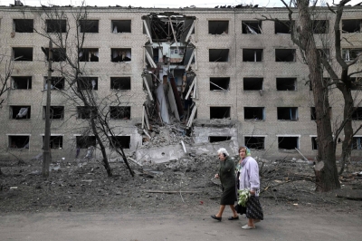 Elderly women walk past a building destroyed during a Russian missile attack in the town of Selydove, in Ukraine's Donetsk region, on April 14. The West needs to take decisive action to support an out-gunned Ukraine before the situation worsens.