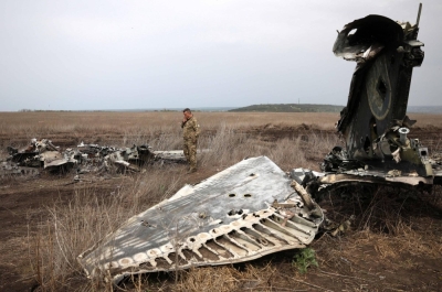 A Ukrainian lieutenant colonel examines the remains of his aircraft on the outskirts of the town of Izyum, Kharkiv region, on Wednesday.