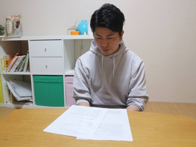 Takuya Matsunaga reads a reply from Kozo Iizuka, imprisoned for killing Matsunaga's wife and daughter in 2019 in a high-profile accident in Tokyo's Ikebukuro district, at his home in Tokyo earlier this month.