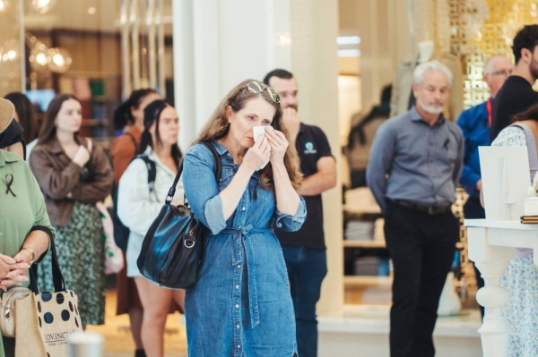 A woman reacts at a memorial set up for victims victims of a stabbing attack at Westfield shopping mall in Bondi Junction in Sydney, on Thursday. 
