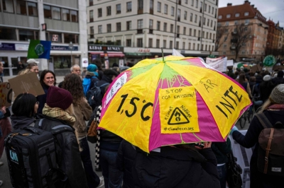 An activist holds an umbrella during a Fridays for Future movement climate strike on Friday in Stockholm.