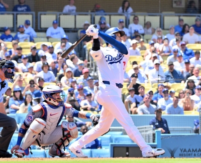 Dodgers designated hitter Shohei Ohtani hits a two-run home run against the Mets during the third inning at Dodger Stadium in Los Angeles on Sunday. The home run was the 176th of his MLB career, breaking a tie with Hideki Matsui for the most by a Japanese-born player.