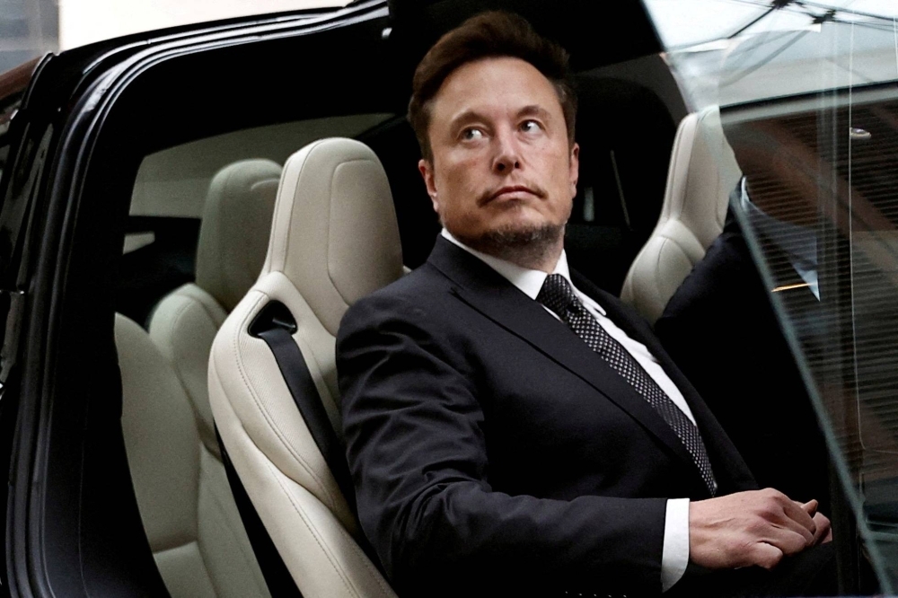 Tesla Chief Executive Officer Elon Musk gets in a Tesla car as he leaves a hotel in Beijing in May last year.