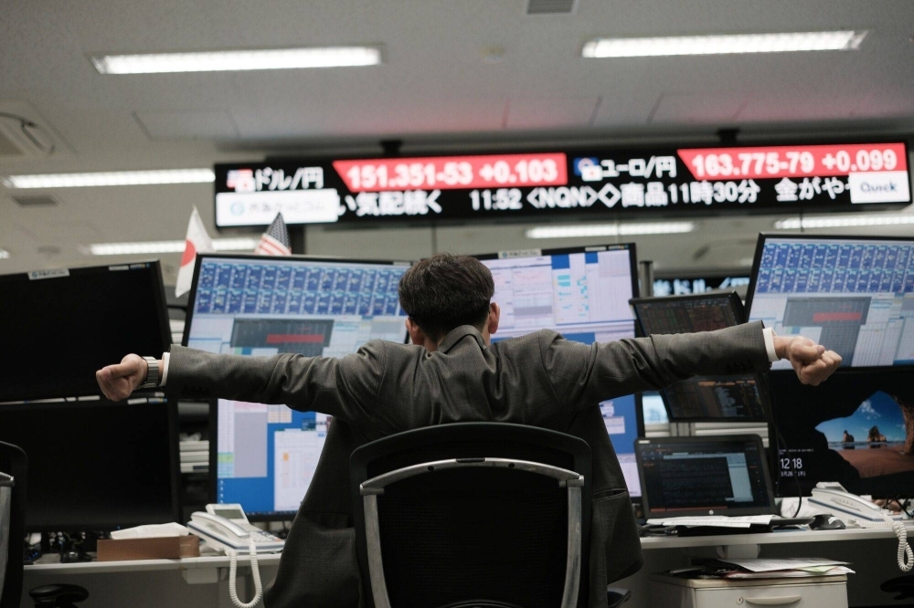 A dealer works in the trading room at a foreign exchange brokerage in Tokyo on March 28. An overwhelming majority of respondents who currently work remotely in some capacity say they wish to continue to do so.