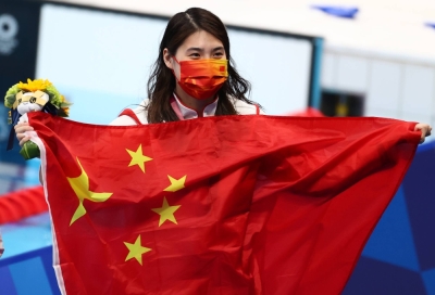 Chinese swimmer Zhang Yufei poses with her gold medal after winning the women's 200-meter butterfly during the Tokyo Games. 