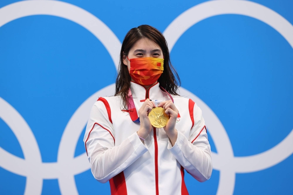 Zhang Yufei celebrates after winning the women's 200-meter butterfly at the Tokyo Olympics. Zhang is one of 23 Chinese swimmers who tested positive for a banned substance seven months before the Games.