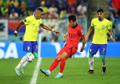 South Korea's Son Jun-ho (center) in action against Brazil's Raphinha during a 2022 World Cup Round of 16 clash in Doha.