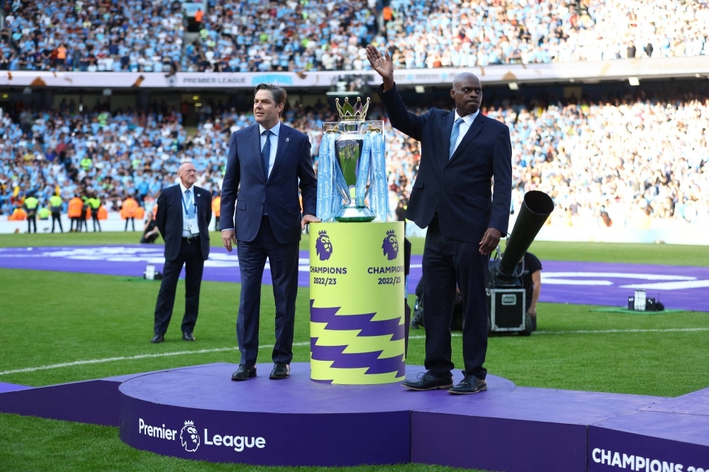 Premier League chief executive Richard Masters (left) stands with the Premier League trophy in Manchester on May 21.