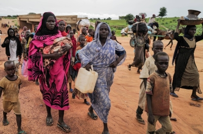 Sudanese refugees fleeing the conflict in the country's Darfur region cross the border into Chad in August. 