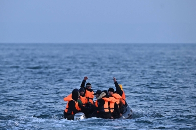Migrants travel in an inflatable boat across the English Channel, bound for Dover on the south coast of England.