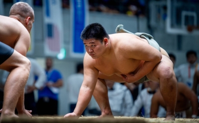 Wrestlers prepare for the start of a bout at the 2023 Sumo World Championships in Tokyo. Starting this month, placing one hand on the clay first is no longer allowed.