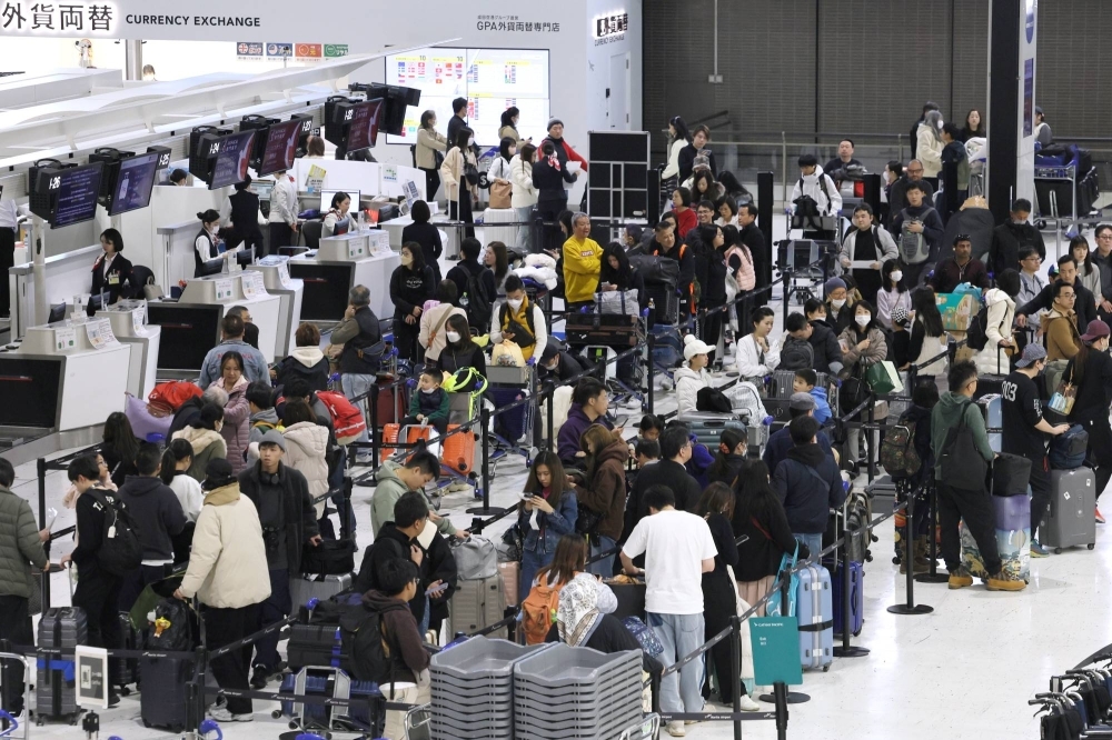 Check-in counters at Narita International Airport are crowded with travelers on Dec. 30, 2023.  