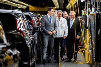 Canadian Prime Minister Justin Trudeau (left), Honda CEO Toshihiro Mibe (center) and Ontario Premier Doug Ford walk in the company's automotive assembly plant in Alliston, Ontario, on Thursday.
