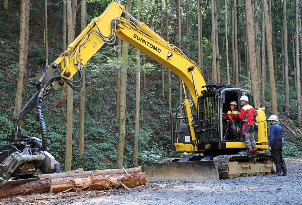 Prime Minister Fumio Kishida rides on a forestry processor during an inspection of afforestation in Hitachiomiya, Ibaraki Prefecture, in October.