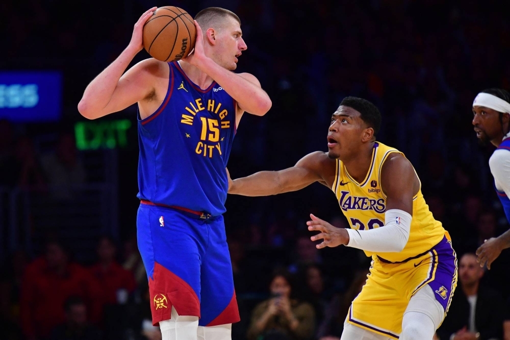 Nuggets center Nikola Jokic is guarded by the Lakers' Rui Hachimura during the second half in Game 3 of their first-round series in Los Angeles on Thursday.