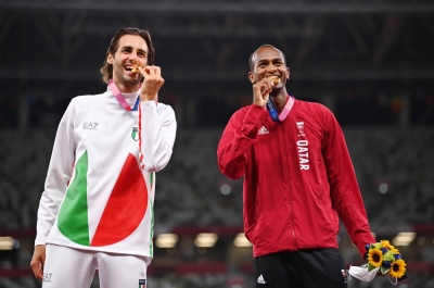 Gold medalists Gianmarco Tamberi of Italy and Mutaz Essa Barshim of Qatar on the podium following the men's high jump competition, at National Stadium in Tokyo in 2021. 
