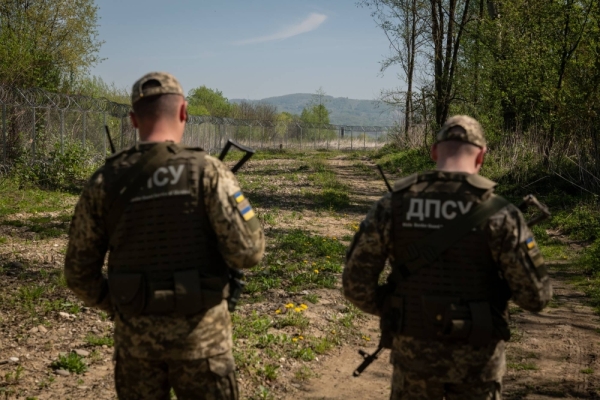 Ukrainian guards patrol a stretch of land on the border with Romania. New guidance carries a clear message to Ukrainian men abroad who may be avoiding the draft: You don’t get the benefit of state services if you don’t join the fight.