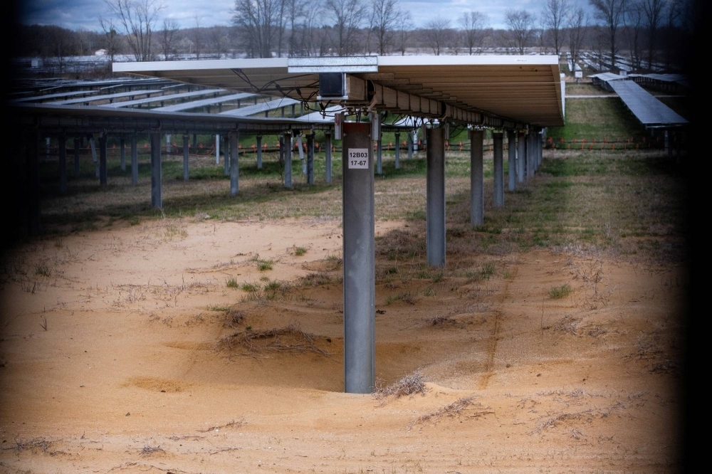Sandy soil is eroding from the base of solar panels located on Dave Duttlinger's farmland in Weatfield, Indiana