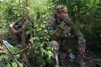 Ukrainian servicemen rest at a side of a road leading toward the Ocheretyne area in the Donetsk region on Sunday.