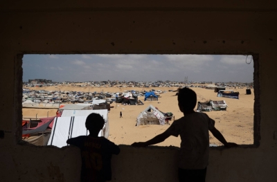 Palestinian children stand in a camp for displaced people in Rafah in the southern Gaza Strip by the border with Egypt on Sunday.