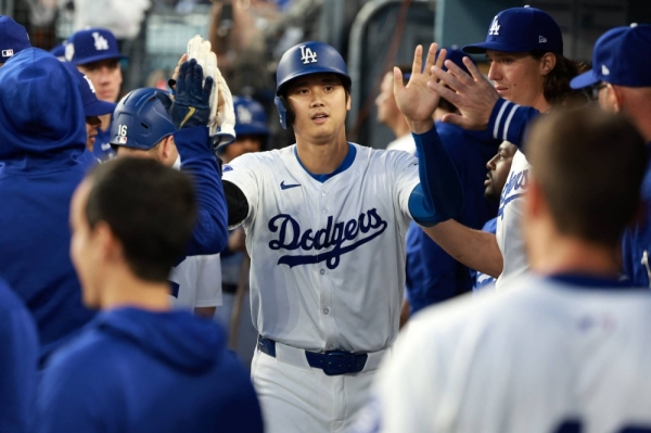 Shohei Ohtani is congratulated by his teammates after scoring a run against the Nationals in the first inning at Dodger Stadium in Los Angeles on April 15.