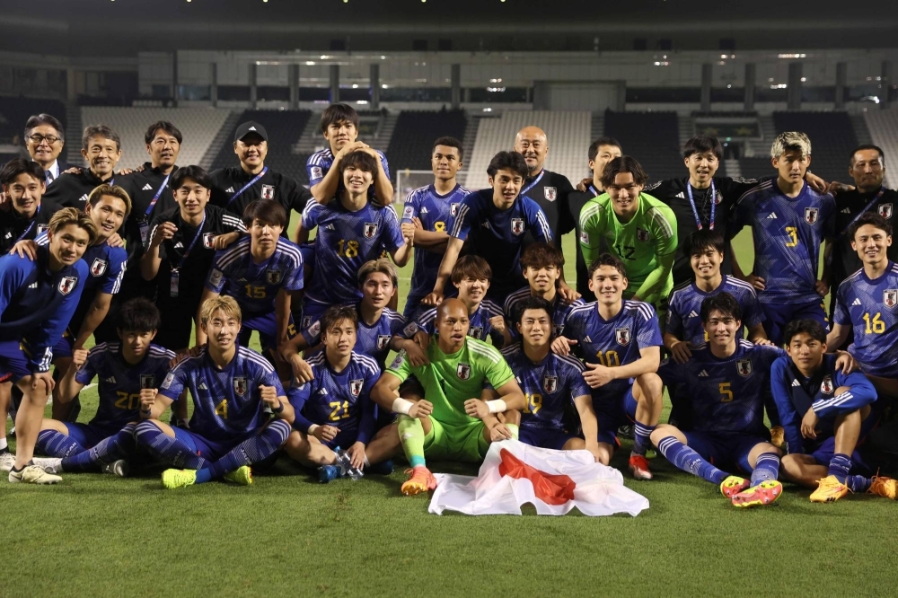 Japan's players pose for a picture after defeating Iraq in an Under-23 Asian Cup semifinal match in Doha on Monday.