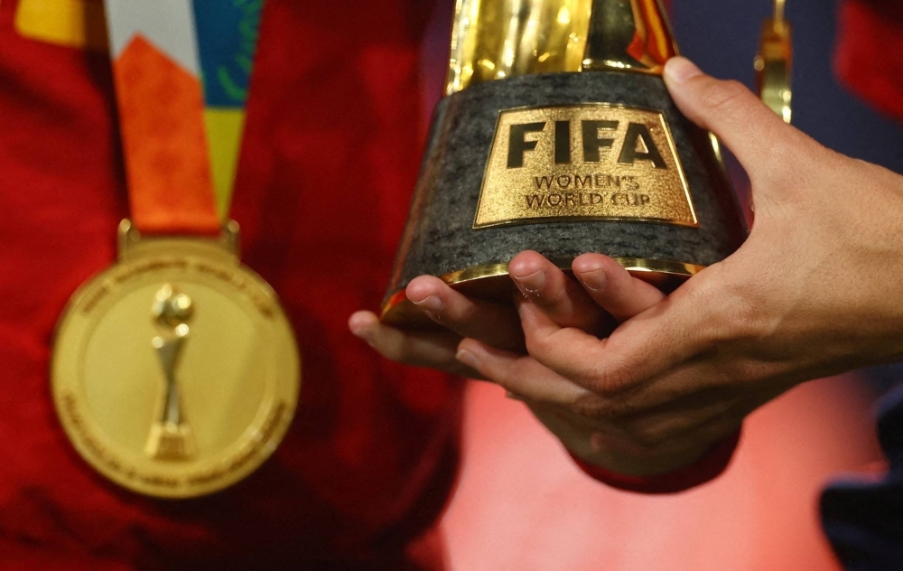 A Spain player holds the Women's World Cup trophy after the team won the 2023 tournament, in Sydney on Aug. 20.