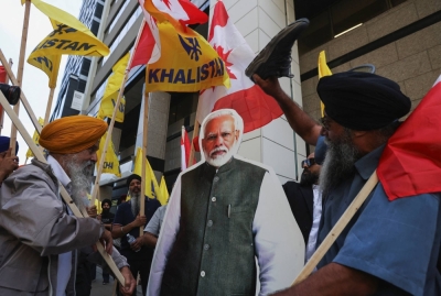 Demonstrators surround a cardboard cutout of Indian Prime Minister Narendra Modi during a protest outside the Indian Consulate in Toronto after Canadian Prime Minister Justin Trudeau raised the prospect of New Delhi's involvement in the murder of Sikh separatist leader in the country last September.