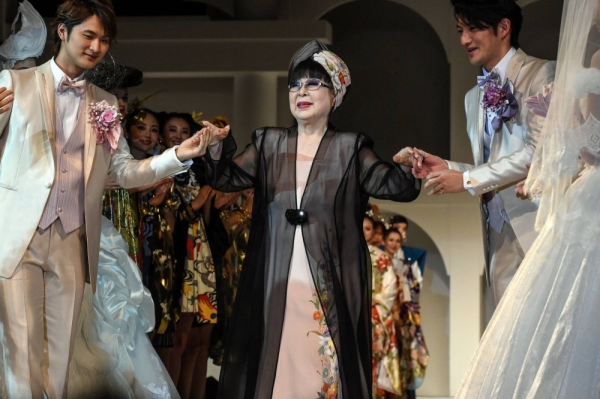 Japanese fashion designer Yumi Katsura (center) greets guests during the finale of the 2015 Yumi Katsura Grand Collection in Tokyo. Katsura has died at the age of 94.