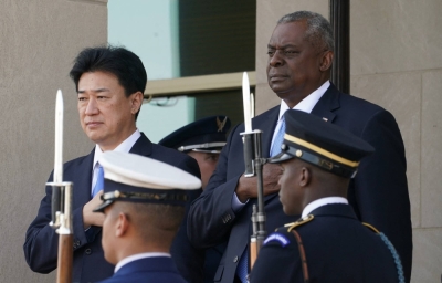 Defense Minister Minoru Kihara takes part in an arrival ceremony with U.S. Secretary of Defense Lloyd Austin at the Pentagon in Washington last October.