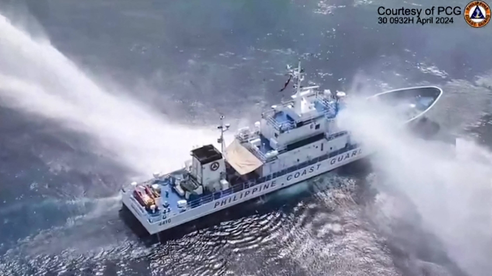 The Philippine Coast Guard ship BRP Bagacay being hit by water cannon from China Coast Guard vessels near the Chinese-controlled Scarborough shoal in the disputed South China Sea in this screen shot from video taken and released Tuesday.