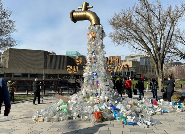 A prop depicting a water tap with cascading plastic bottles is displayed by activists near the Shaw Center venue of penultimate negotiations for the first-ever global plastics treaty, in Ottawa, Canada, on April 23.