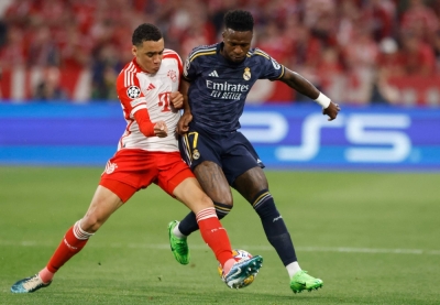 Bayern Munich midfielder Jamal Musiala (left) battles with Real Madrid's Vinicius Junior during the first leg of the Champions League semifinals on Tuesday in Munich. 