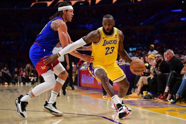 Lakers forward LeBron James dribbles toward the basket during Game Three of Los Angeles' first-round series against the Nuggets on April 25. 